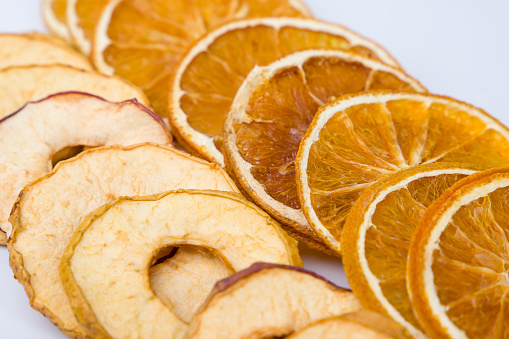 Dried orange and dried apple fruit slices. Close-up.