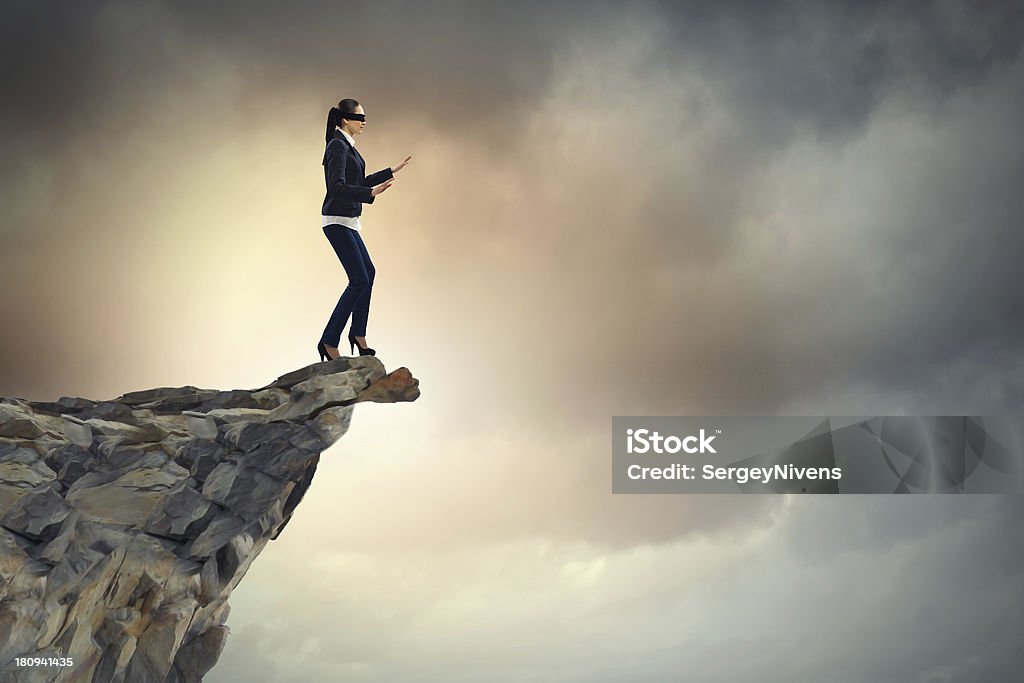 Businesswoman in blindfold businesswoman in blindfold standing on edge of mountain Adult Stock Photo