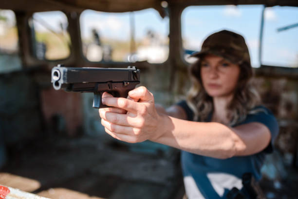 istock Woman with a pistol in her hand learns to shoot 1809419992