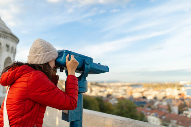 Woman at Fisherman's bastion in Budapest looking through telescope Woman at Fisherman's bastion in Budapest, enjoying the view, looking through spotting scope.
It is one of the most important monument and tourist and well known tourist attractions due to the unique panorama of Budapest. This famous current structure are built between 1895 and 1902. fishermens bastion photos stock pictures, royalty-free photos & images