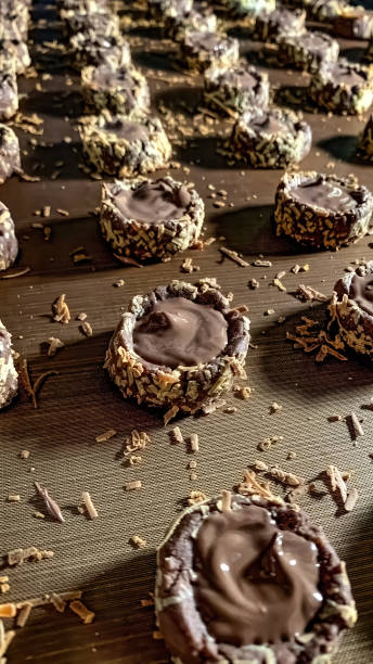 some Belgian chocolate mini cookies topped with oat flakes that have just finished in the oven