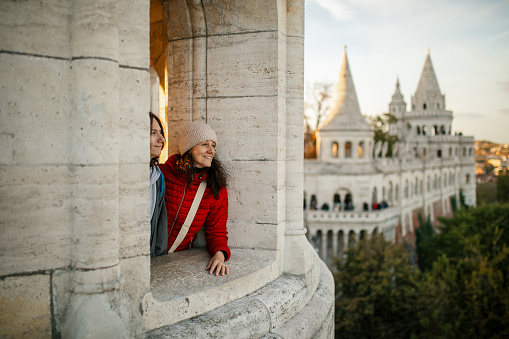 Mother and son at Fisherman's bastion in Budapest, enjoying the view, looking happy and relaxed.\nIt is one of the most important monument and tourist and well known tourist attractions due to the unique panorama of Budapest. This famous current structure are built between 1895 and 1902.