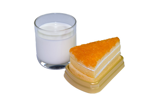 Glass filled with white milk and orange cake Freedom to come together to eat together on an easily distinguishable white background.