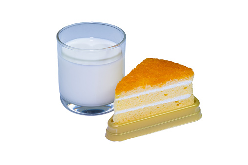 Glass filled with white milk and orange cake Freedom to come together to eat together on an easily distinguishable white background.
