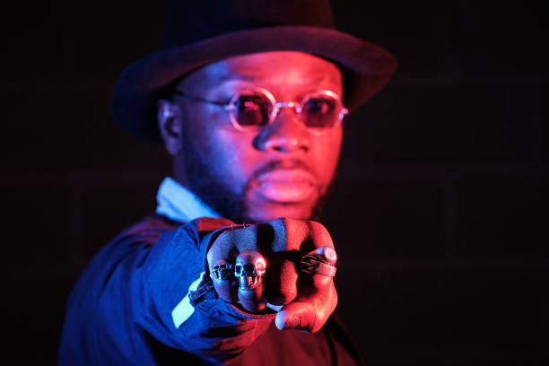 istock Stylish black guy in sunglasses showing fist in studio 1809425718