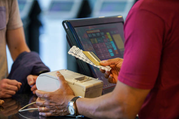 Rear shot of unidentified person's hands holding recently purchased movie tickets