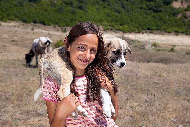 istock Shepherd girl with puppy 180942799
