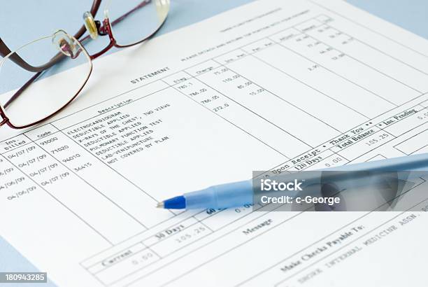 Close Up Of A Medical Bill Featuring Glasses And A Pen Stock Photo - Download Image Now