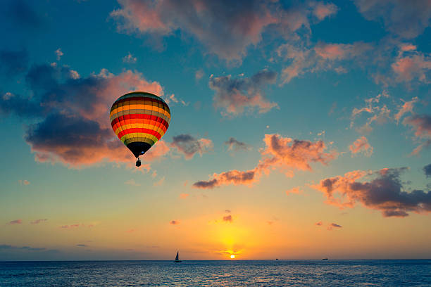 Hot air balloon with sunset at the sea background
