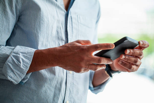 istock Unidentified person's hands holding cell phone 1809435277