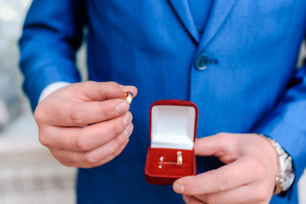istock A man holds wedding rings in a red box in his hands 1809436360