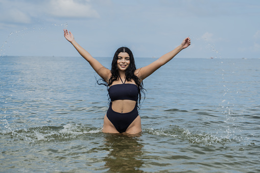 Portrait of a young woman having fun in the sea