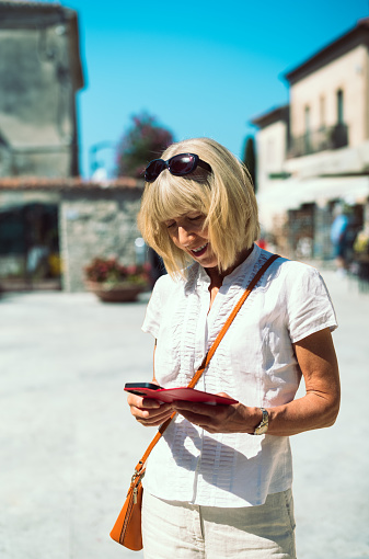 Female tourist at the village of Paestum about to explore the ancient remains of the Roman Grecian settlement. It is located south of Salerno, Italy.