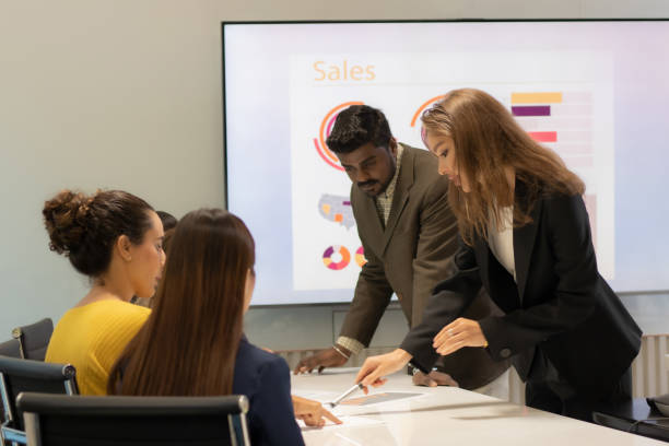 istock Business people presenting and managers planning, teamwork or discussion for project proposal or marketing Group of men and women discuss, question and collaborate on design. 1809452415