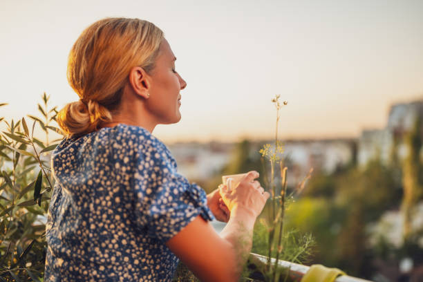 istock Woman drinking coffee at sunset 1809461133