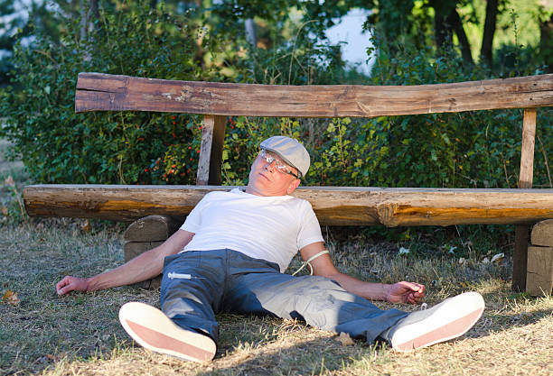 istock Drug addict lying in a park 180946204