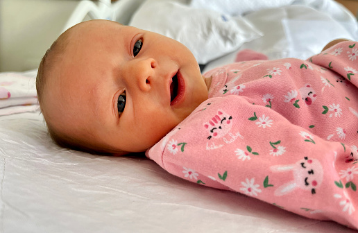 Week old baby girl in pink pyjamas