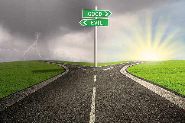 Road sign of good vs evil Road sign of good vs evil on stormy background evil stock pictures, royalty-free photos & images