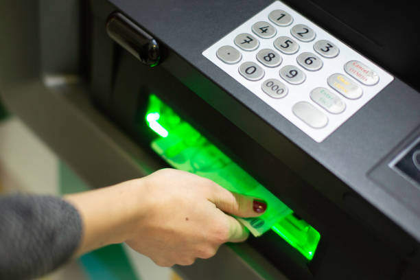 istock receiving money from an ATM 1809471191