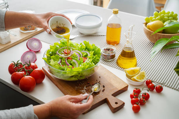 istock Woman dressing healthy lettuce salad 1809487721