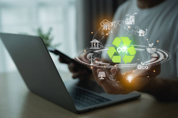 istock Man holding earth use laptop recycle virtual screen symbol modern reduce CO2 emission with icons, global warming emissions carbon footprint climate. Renewable energy-based green businesses can limit. 1809488231