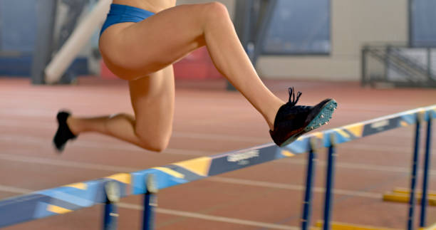 istock Woman jumping over hurdle 1809495144