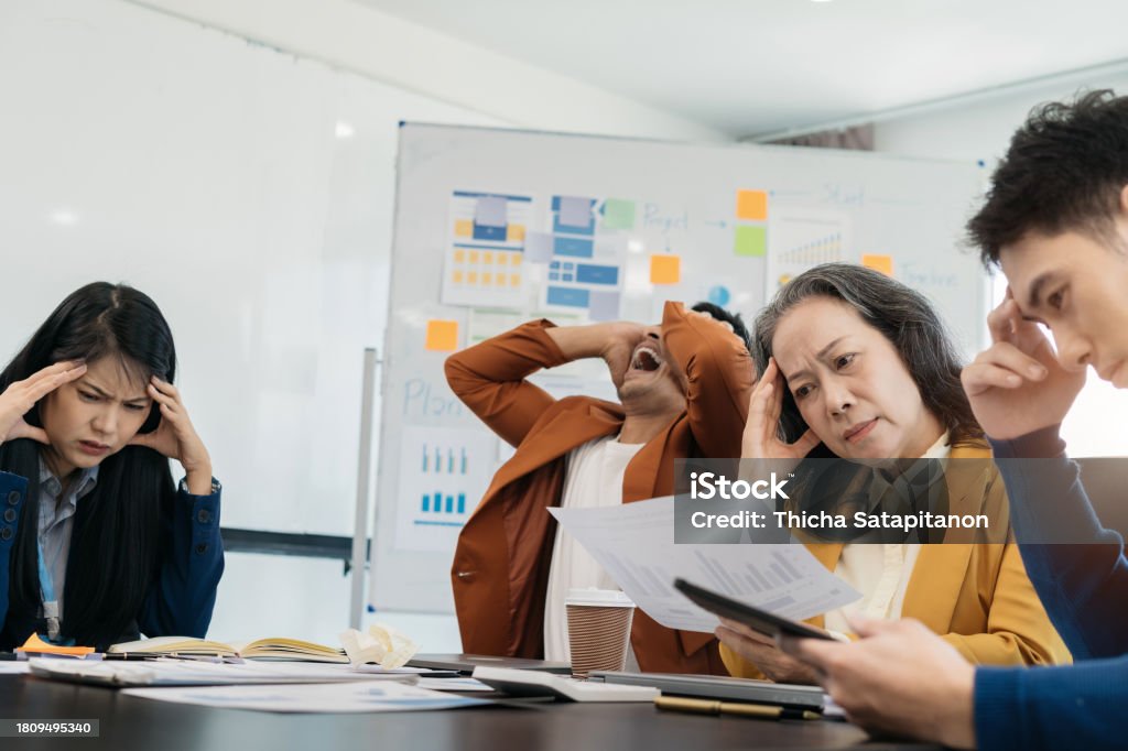 Miserable Team Business Team Sitting Sad And Solving Problems In The Office Failed ...