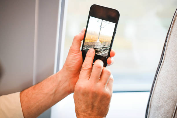 istock Passenger in a train carriage with a mobile phone 1809498454