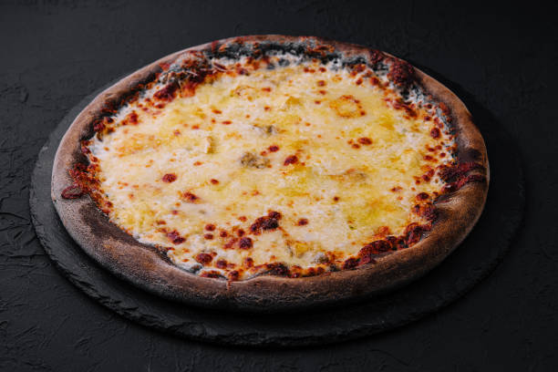 istock black pizza with cheese on stone 1809499055