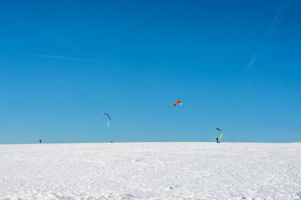 istock Kitesurfing in the snow with a blue sky 1809502379