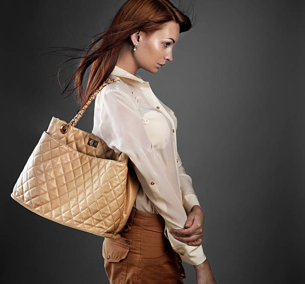 Attractive woman in stylish clothes with red bag and perfect makeup
