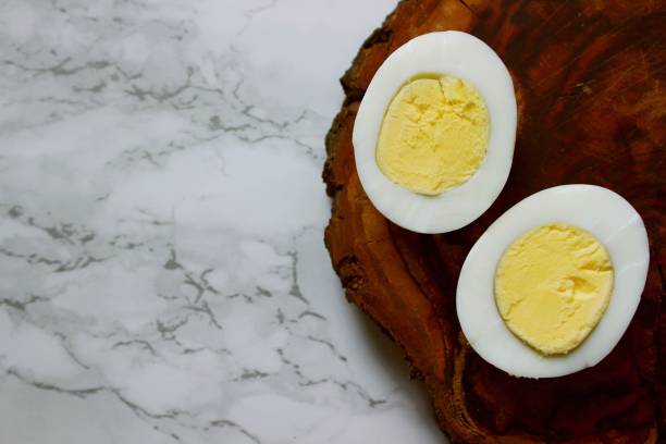 istock Boiled chicken egg on a wooden board on a marble background 1809507767