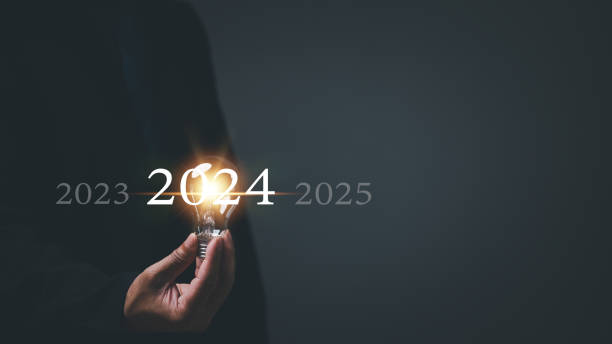 istock Startup concept. Man holding a light bulb. With a clear vision and strategic plan, a determined businessman navigates the trends of 2024, paving the way for a prosperous future. 1809510280