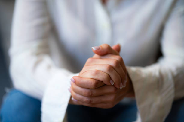 istock Closeup of woman's folded hands 1809528144