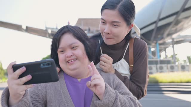 Young disabled woman with Down syndrome is happy and traveling on an outdoor vacation with an Asian family.