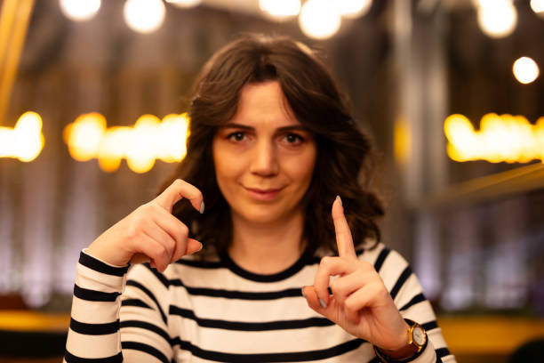Two young woman speak in sign language