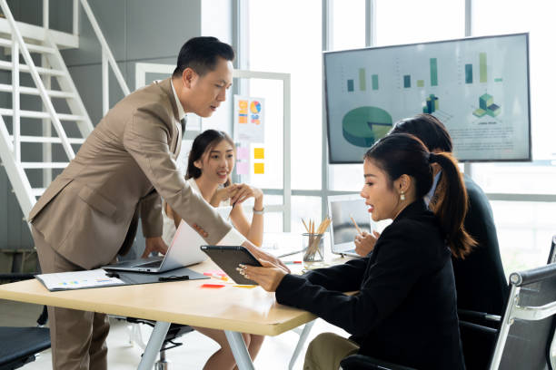 istock Asian Business People Discuss Project in Conference Room 1809554389