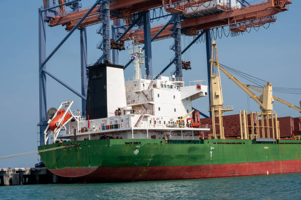 istock crane loading cargo container from truck to container ship in the international terminal logistic sea port concept freight shipping by ship, webinar banner forwarder mast. 1809557668