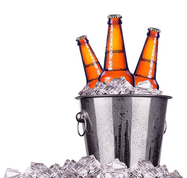 Beer bottles in ice bucket isolated stock photo