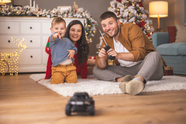 istock Mother and father playing with their son while spending Christmas day at home 1809563929