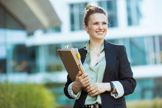 istock smiling modern woman worker in business district 1809567358