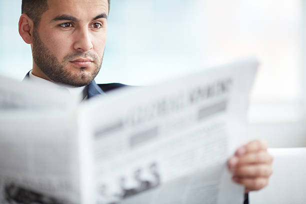 istock A business man reading the newspaper 180956744