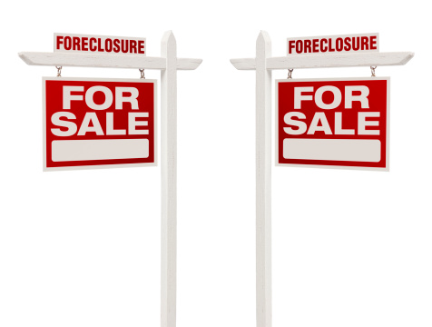 Pair of Left and Right Facing Foreclosure For Sale Real Estate Signs With Clipping Path Isolated on White.