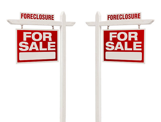 Two Foreclosure For Sale Real Estate Signs with Clipping Path stock photo