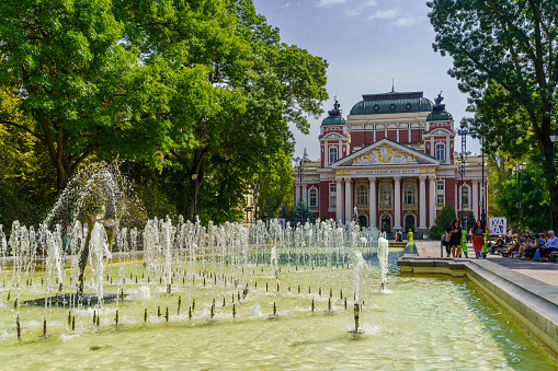 Sofia, Bulgaria - September 14, 2023: View of the city garden, with the Dancing Ballerina fountain, Ivan Vazov National Theater, Locals and Visitors, in Sofia, Bulgaria