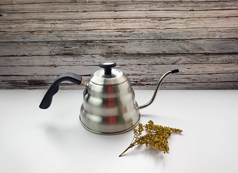 Wooden kitchen background with metal kettle