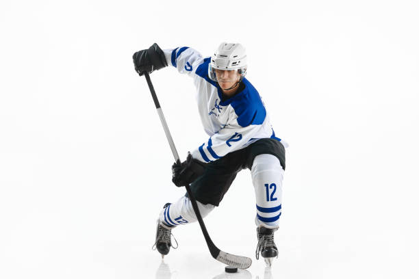 istock Champion. Young man, hockey player during game, training, playing against white studio background 1809600287