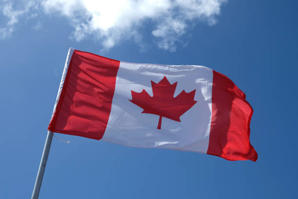 canadian flag waving - canada american flag canadian culture usa imagens e fotografias de stock
