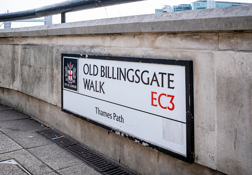 A City of London street sign for Old Billingsgate Walk, which runs beside the River Thames and is part of the Thames Path, which runs from the source of the Thames in the Cotswolds to Woolwich.