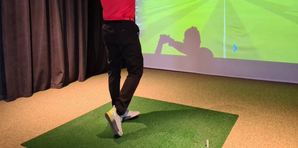 istock Young man plays golf indoors. Golf simulator 1809614780